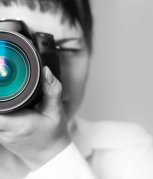 Portrait,Of,A,Photographer,Covering,Her,Face,With,The,Camera